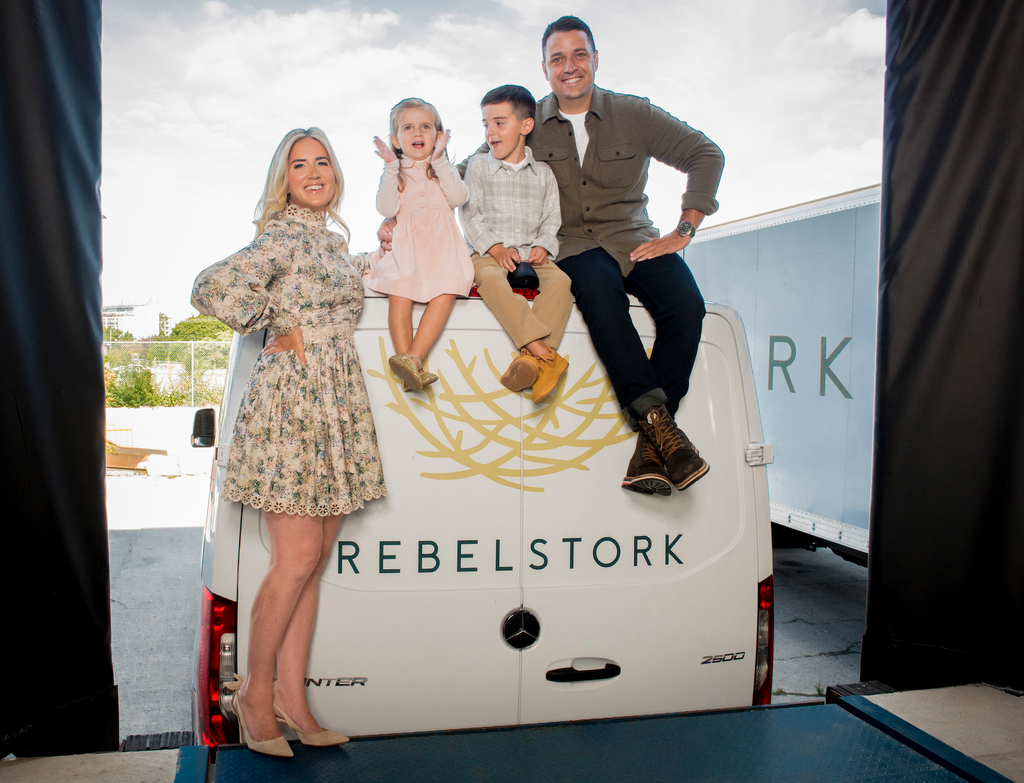 Emily, the CEO of Rebelstork, and her family posing with a Rebelstork delivery van.