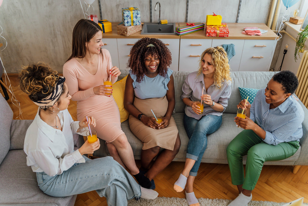 Three women at a baby shower after learning how to plan a baby shower