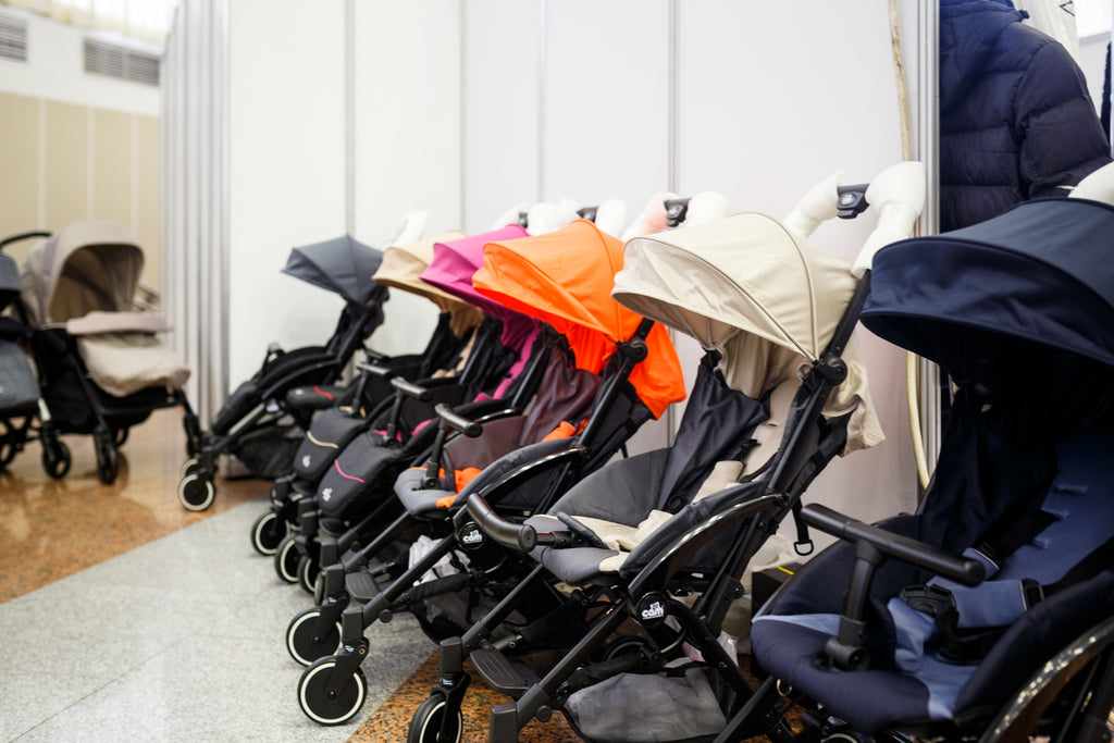 Line of different colored trendy strollers at an indoor mall